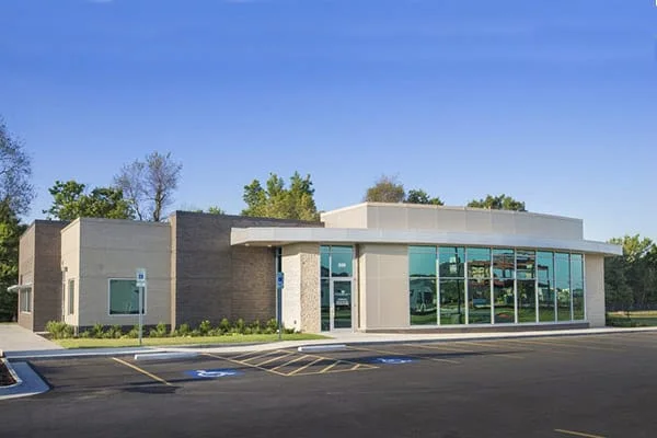 The practice building at 601 SW Regional Airport Blvd, glass frontage under a blue sky