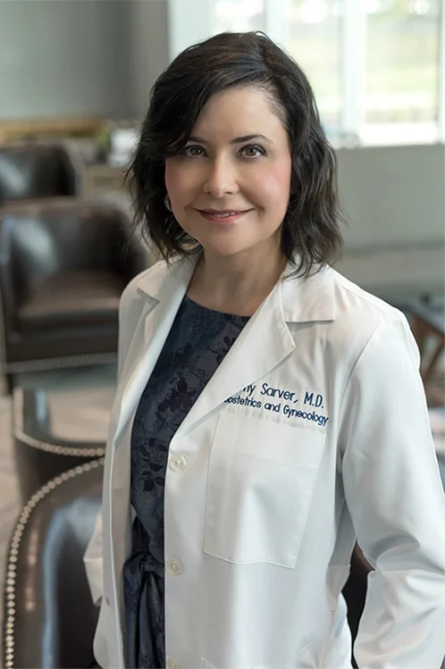Dr. Amy Sarver in a white coat embroidered Obstetrics and Gynecology